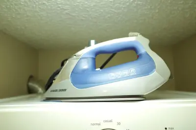 a blue and white iron sitting on top of a refrigerator at Capilano Happylife in North Vancouver