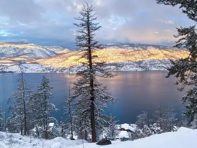 a view of a lake in the snow at Kelowfornia Lakeview Retreat in Kelowna