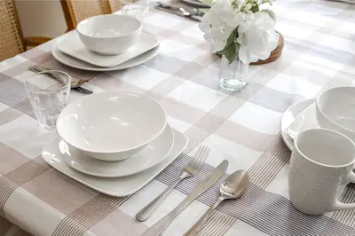 a table with plates and silverware on a checkered table cloth at Airport 4BR2BA Mainfloor Suite 1min walk to bus stop in Calgary