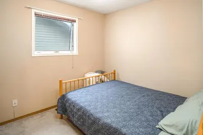 a bedroom with a bed and a window at Airport 4BR2BA Mainfloor Suite 1min walk to bus stop in Calgary