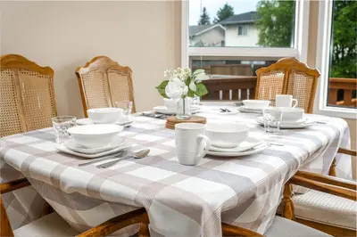 a dining room table with a checkered table cloth at Airport 4BR2BA Mainfloor Suite 1min walk to bus stop in Calgary