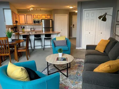 a living room with two couches and a table at Borgata Lodge Resort in Kelowna