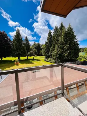 a balcony with a view of a park at Oceanside Manor - Fancy Room - Golf course & Beach View in Qualicum Beach