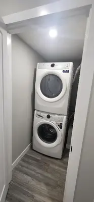 a washer and dryer in a small room at fabulous and cozy guest suite in Calgary