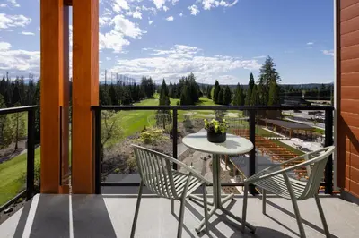 a balcony with a table and chairs and a view at Naturally Pacific Resort in Campbell River