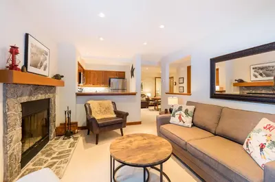 a living room with a couch and a fireplace at #24 Treeline in Whistler