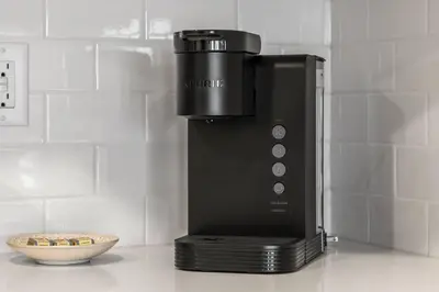a coffee maker sitting on a counter next to a bowl at Brand New Luxury Walk-out Suite - Calgary in Calgary