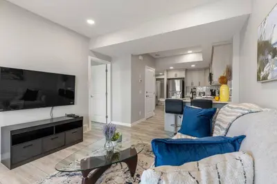 a living room with a couch and a table at Brand New Luxury Walk-out Suite - Calgary in Calgary