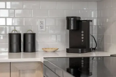 a kitchen with two coffee makers on a counter at Brand New Luxury Walk-out Suite - Calgary in Calgary