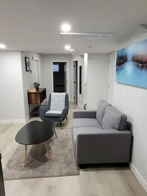 a living room with a couch and a chair at Beautiful Comfy Guest Suite in West EDM in Edmonton