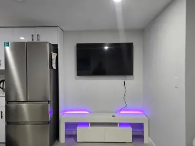 a room with a refrigerator and a table with purple lights at Beautiful Comfy Guest Suite in West EDM in Edmonton