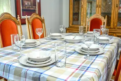 a table with glasses and plates and dishes on it at Nice 3 Bedroom 2 Bathroom Home Fenced yard near Downtown and YYC in Calgary