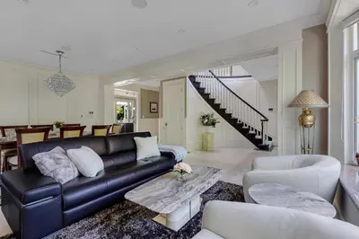 a living room with a black leather couch at Luxurious Multi-Family Home in Vancouver West, 10 Mins Downtown in Vancouver