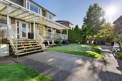 a home with a patio and a lawn at Luxurious Multi-Family Home in Vancouver West, 10 Mins Downtown in Vancouver