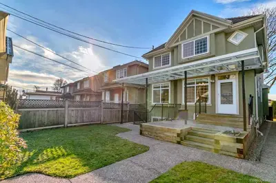 a house with a fence and a yard at Cozy 1bedroom Suite in Vancouver Westside in Vancouver