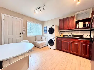 a kitchen with a table and a couch in a room at Cozy 1bedroom Suite in Vancouver Westside in Vancouver
