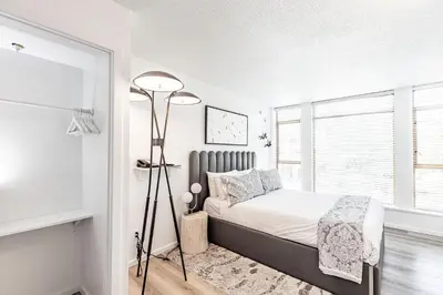 a bedroom with a bed and a window at Cascade Lodge Premium Suite, with Pool & Hot Tub in Whistler