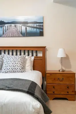 a bedroom with a bed and a dresser with a picture on the wall at Chateau Lawrence, Pool Table, Kids' Gaming Room in Fairmont Hot Springs