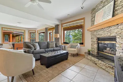 a living room with a couch and a fireplace at Chateau Lawrence, Pool Table, Kids' Gaming Room in Fairmont Hot Springs