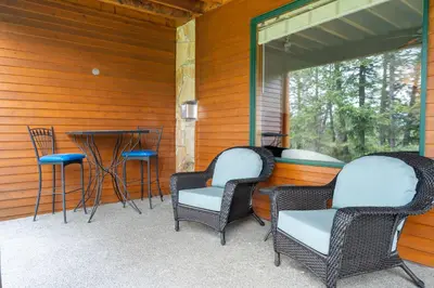 three wicker chairs and a table on a porch at Chateau Lawrence, Pool Table, Kids' Gaming Room in Fairmont Hot Springs