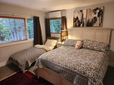 a bedroom with a bed with a teddy bear on it at 2BD Guest Suite Sleeps 6 Near Downtown & Beach in West Vancouver