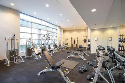 a gym with treadmills and machines in a room at The Altitude with Mountain & City Views, Pool & Hot Tub in Vancouver