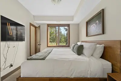 a bedroom with a large white bed with a window at Grizzly Springs, Outdoor Pool, Hot Tub, Fireplace in Radium Hot Springs