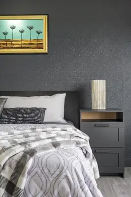 a bedroom with a bed and a nightstand with a picture on the wall at LUXURY LAKEVIEW HOME - 2500sqft of private space with 5 Beds, 4 Bath, 2 Living Rooms, Kitchen, AC, Jacuzzi, 10 Guests Max, Basement Not Included, 18-min to Airport, 20-min to Downtown, 80-min to Banff in Calgary