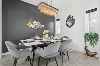 a dining room with a table and chairs at LUXURY LAKEVIEW HOME - 2500sqft of private space with 5 Beds, 4 Bath, 2 Living Rooms, Kitchen, AC, Jacuzzi, 10 Guests Max, Basement Not Included, 18-min to Airport, 20-min to Downtown, 80-min to Banff in Calgary