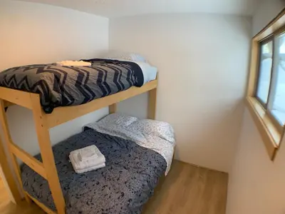a room with two bunk beds and a smaller bed at Eleanor Lodge - Entire House in Blue River in Blue River