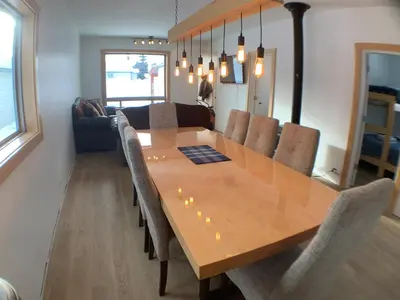 a dining room with a wooden table and chairs at Eleanor Lodge - Entire House in Blue River in Blue River