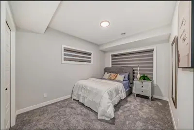 a bedroom with a bed and a window at Cozy Basement Suite in Calgary