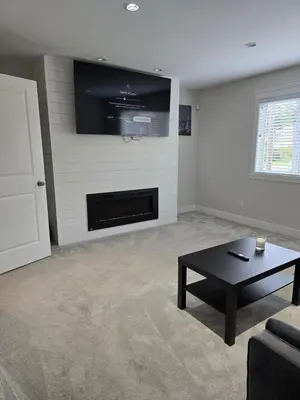 a living room with a tv and a coffee table at Private 1 bedroom in Brookswood in Langley