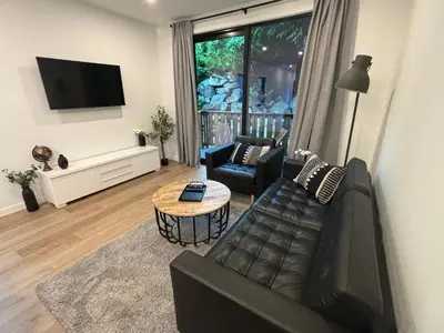 a living room with a couch and a table at cottage NOMAD in Ucluelet