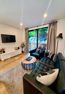 a living room with a couch and a table at cottage NOMAD in Ucluelet