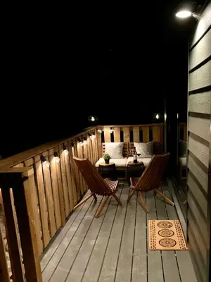 a patio with a table and two chairs on a deck at cottage NOMAD in Ucluelet