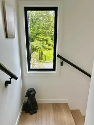 a teddy bear sitting in a room with a window at cottage NOMAD in Ucluelet