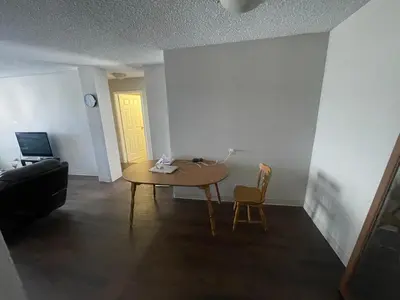 a living room with a table and a couch at florian Apartment in Calgary
