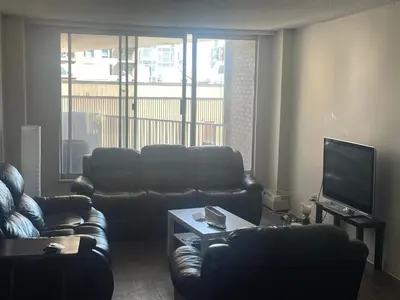a living room with two couches and a television at florian Apartment in Calgary