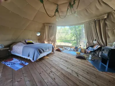 a bedroom with a bed in a tent at D4 Badlands Bunker Dome- 1 Queen Pet Friendly in Drumheller