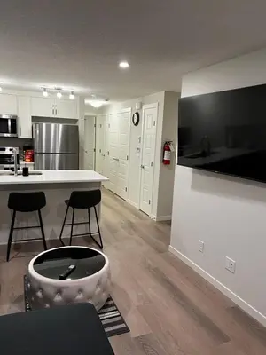 a kitchen with a dog bowl in the middle of a room at The Haven - cozy 1 bedroom suite in Seton SE Calgary in Calgary