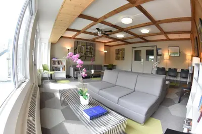 a living room with a couch and a table at HI Calgary City Centre - Hostel in Calgary