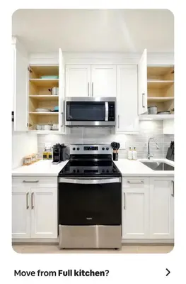 a white kitchen with a stove and a microwave at Cozy Private Suite near YVR Airport in Vancouver