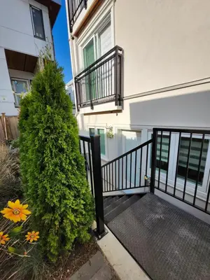 a stairway leading to a building with a plant at Cozy Private Suite near YVR Airport in Vancouver
