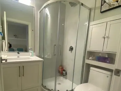 a bathroom with a shower and a toilet and a sink at Cozy Private Suite near YVR Airport in Vancouver