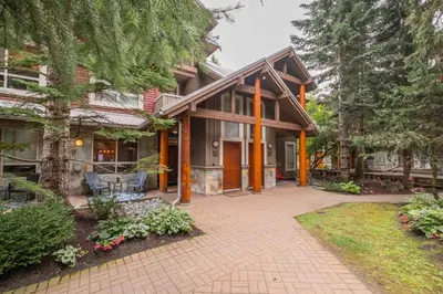 a house with a brick walkway in front of it at Symphony by Outpost Whistler in Whistler