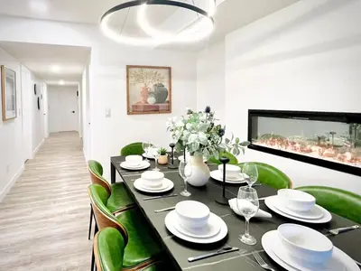 a dining room with a table and green chairs at T201 Brand NEW Downtown Canmore 3BD & 2BT, BBQ, Free Parking in Canmore