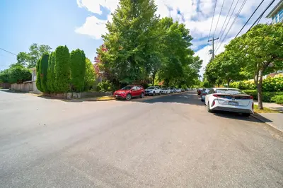 a street with cars parked on the side of the road at Charming Home Near UBC with Parking & Backyard in Vancouver