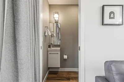a bathroom with a sink and a mirror at K202 Hot tub, Pool, MTN view, AC, free parking in Canmore