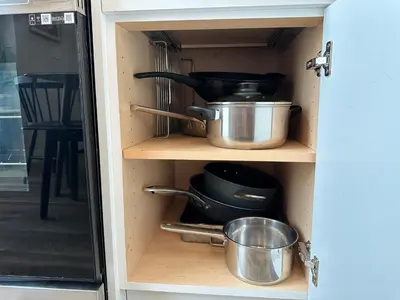 a cupboard with pots and pans in a kitchen at K202 Hot tub, Pool, MTN view, AC, free parking in Canmore